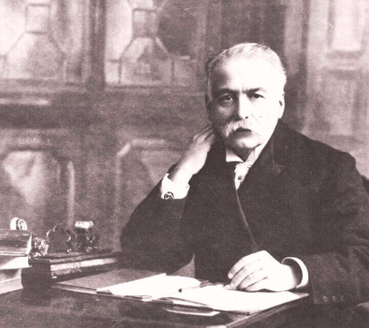 Auguste Escoffier sitting at a desk